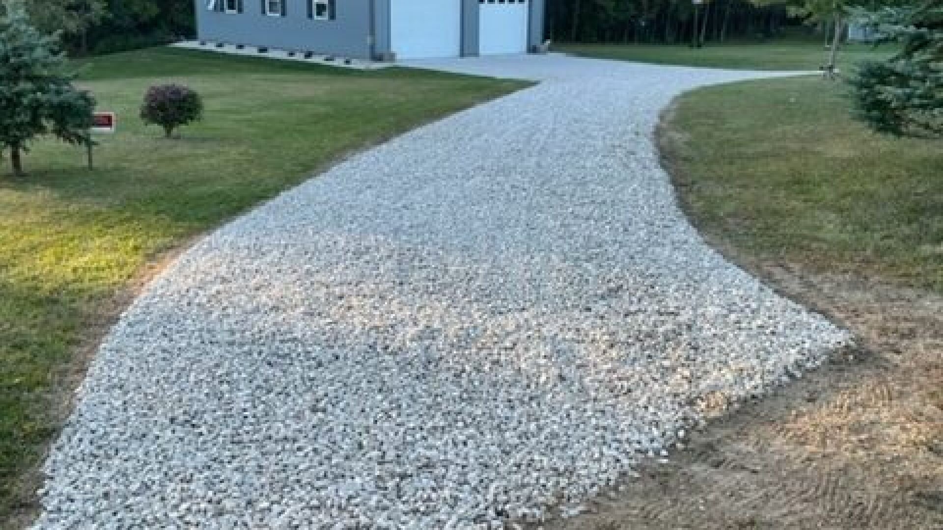 Finished gravel driveway with proper base compaction and drainage